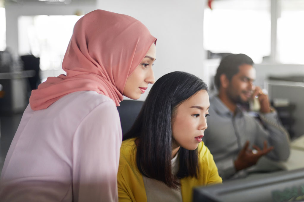 Diverse Group Of Professionals Looking At A Screen