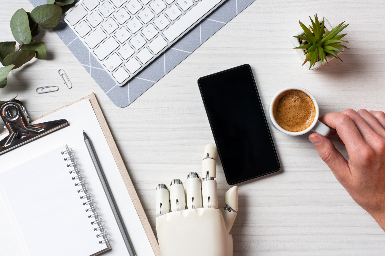 A robot hand and a human hand to represent AI hiring