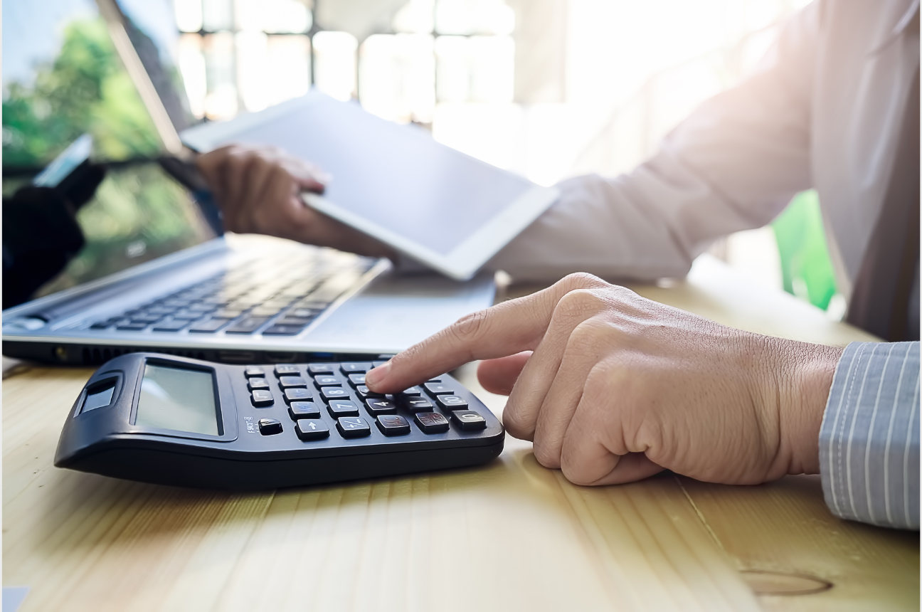 A person using a calculator to represent our HR Tech ROI Calculator