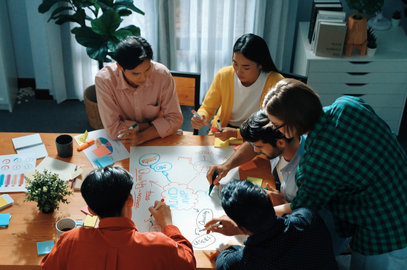 A team working around a table to indicate the top 1% of employees