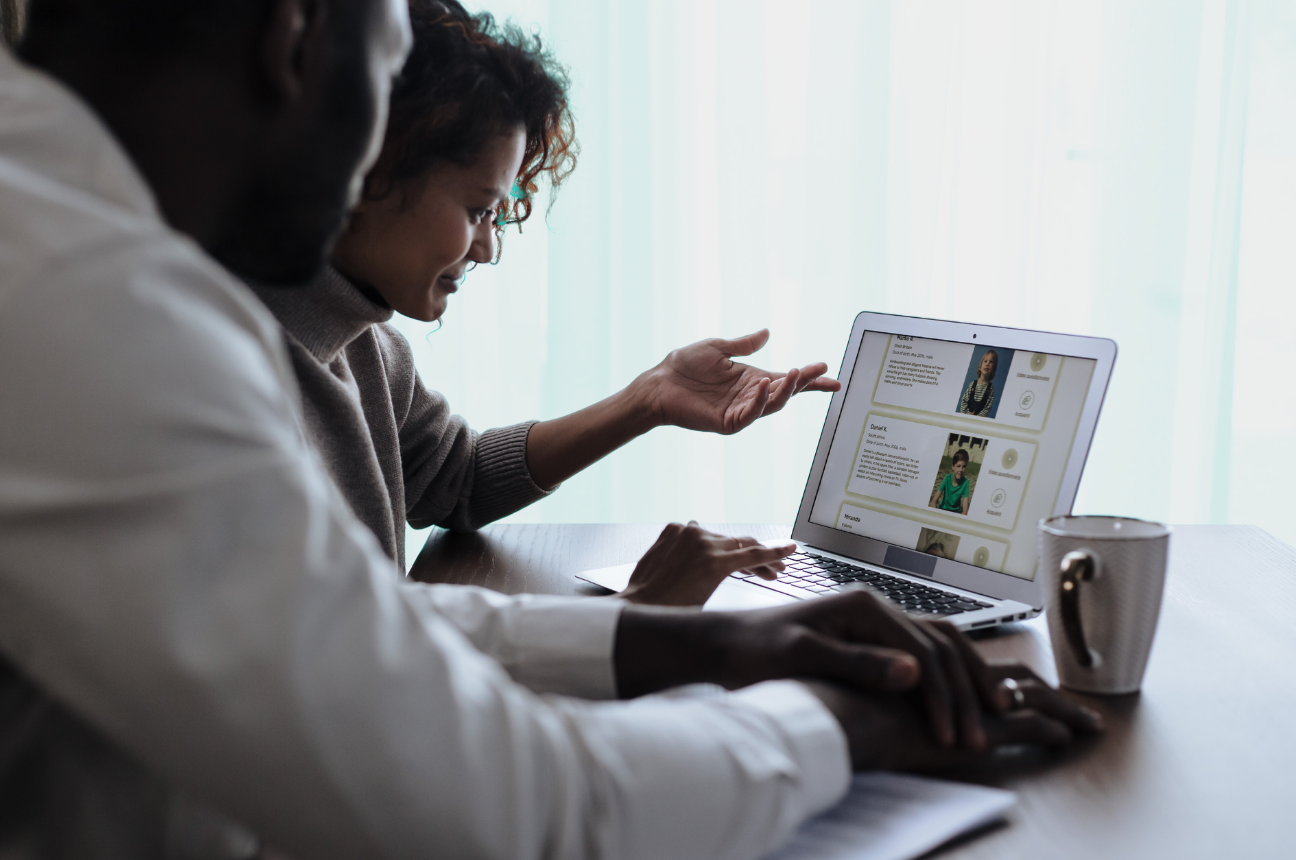 Two people sit at a computer looking over the top ATS platforms of the year